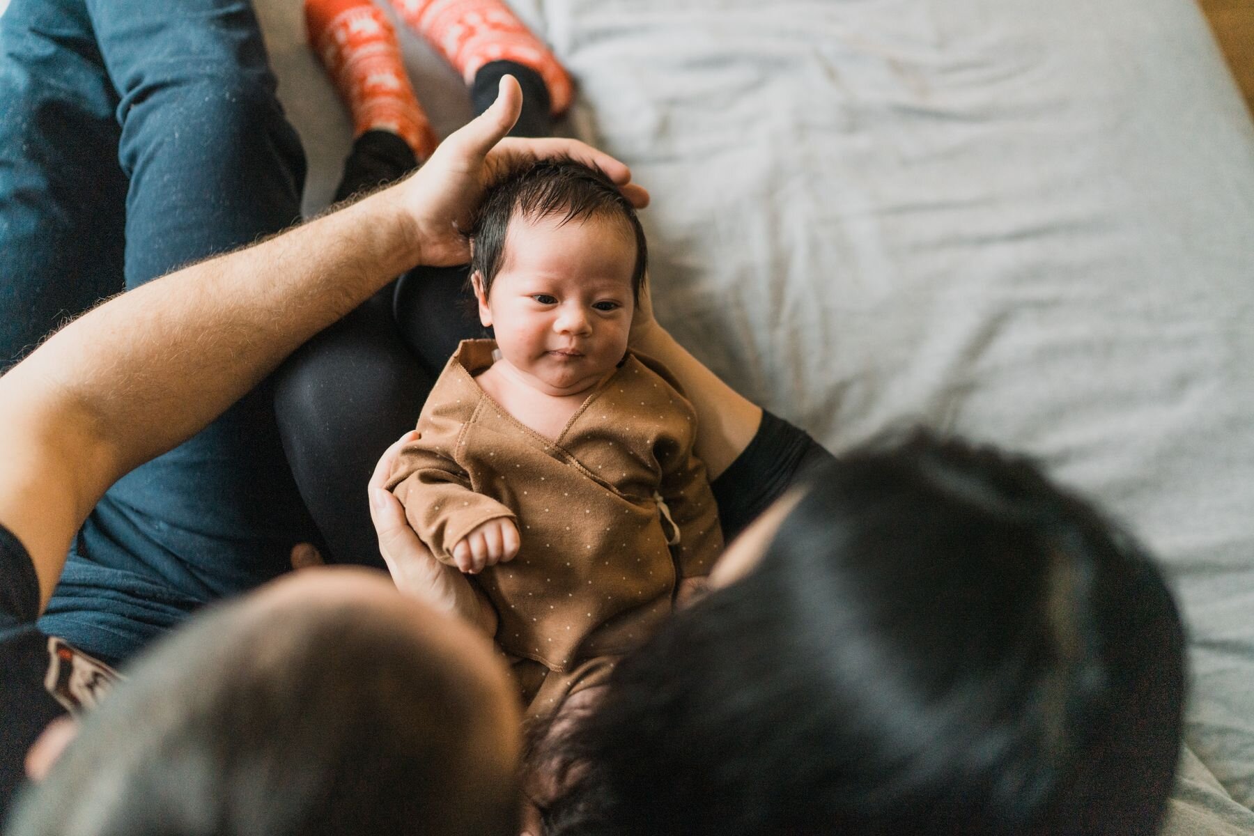 Seattle newborn baby girl looking at mom