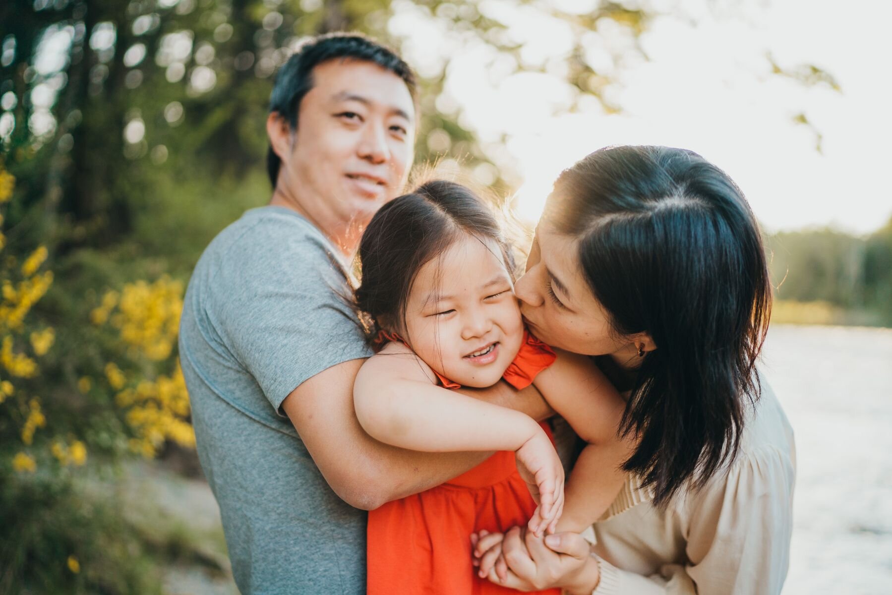 Bellevue family photographer - family of 3 loving on each other