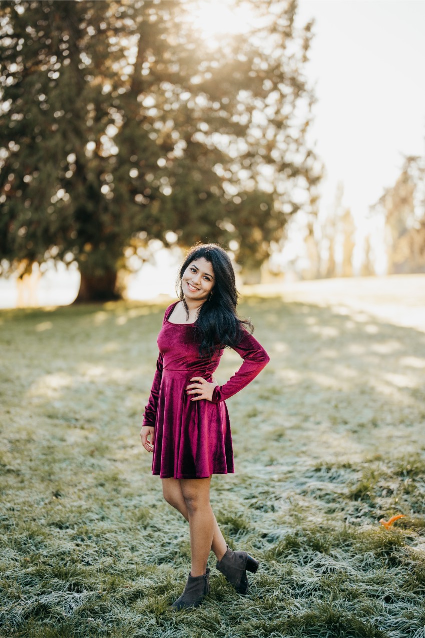 a beautiful portrait of a high school senior girl in golden light in front of a tree at luther burbank park