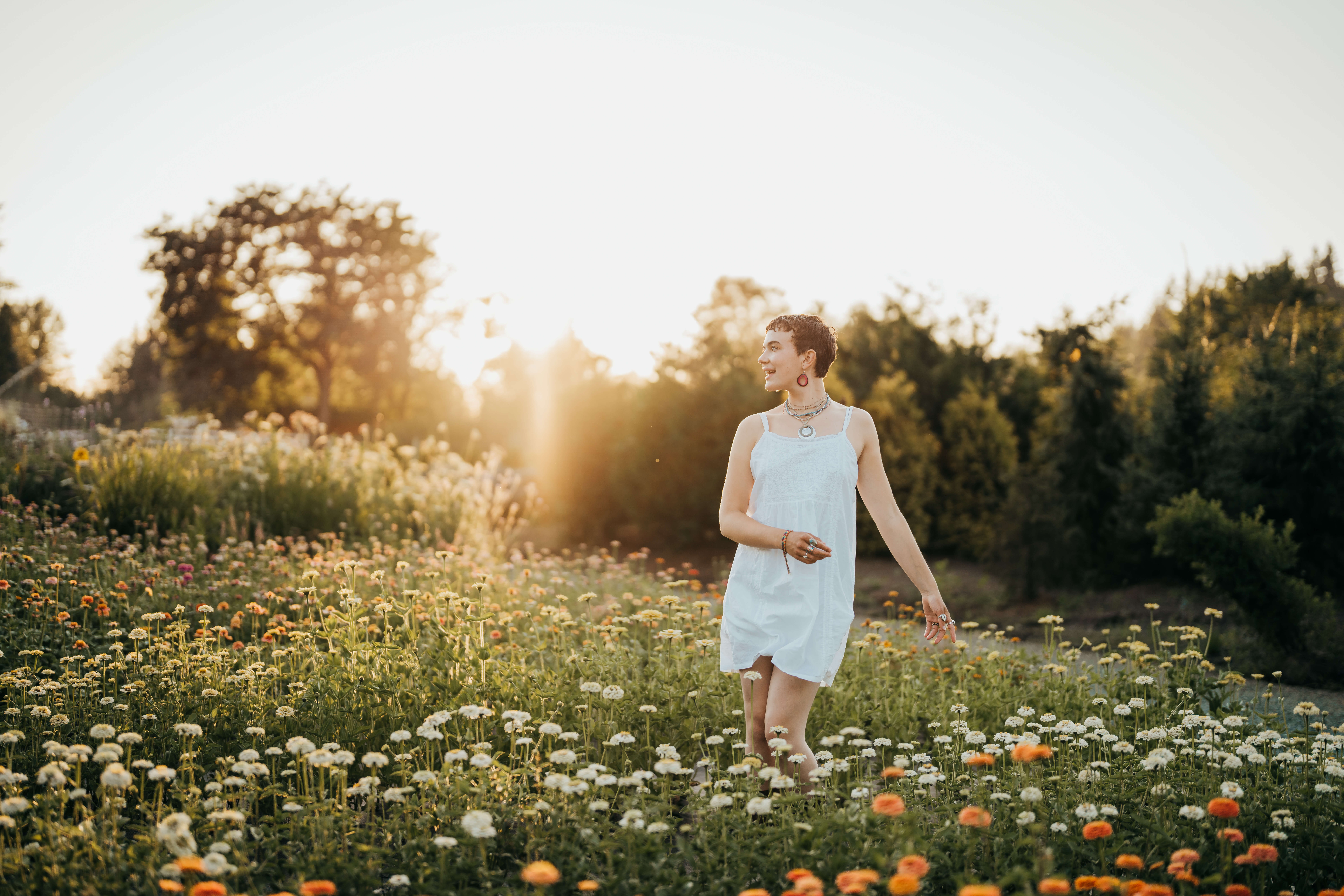 A high school senior in a white dress and hoop earrings after finding supportive College Counselors In Seattle